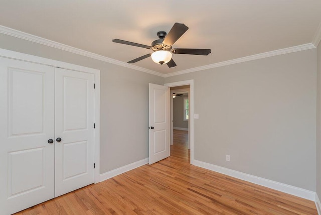 unfurnished bedroom with a closet, ceiling fan, crown molding, and light hardwood / wood-style floors