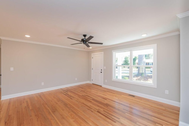 empty room featuring light wood-type flooring, ceiling fan, and crown molding