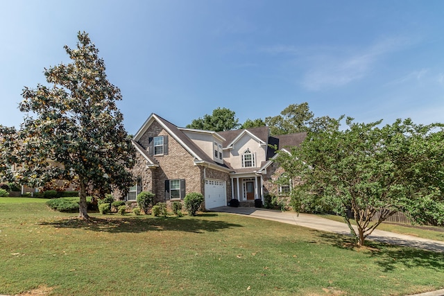 traditional-style home featuring concrete driveway, an attached garage, fence, and a front yard