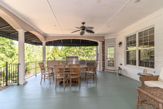 view of patio featuring area for grilling, ceiling fan, outdoor dining area, and a sink