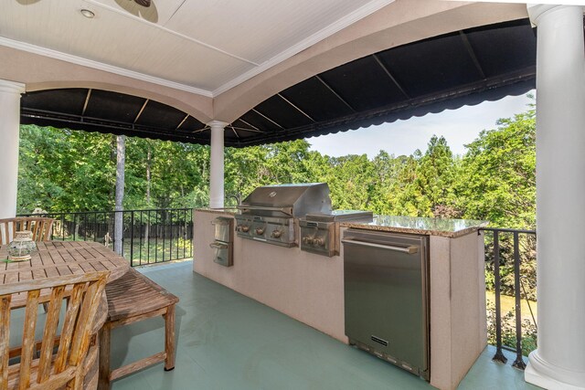 view of patio / terrace with an outdoor kitchen and a grill
