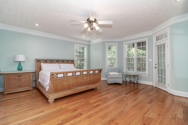bedroom featuring baseboards, access to outside, light wood-type flooring, and a textured ceiling