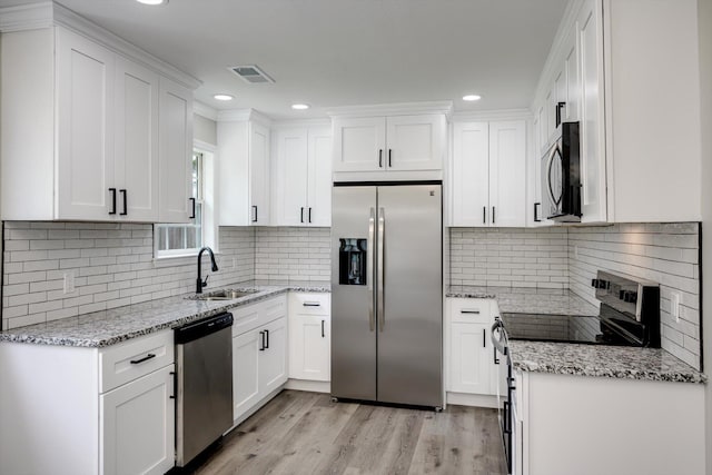 1178 Huntly Cir, Thomson, GA 30824 - kitchen featuring appliances with stainless steel finishes, white cabinets, light stone counters, and recessed lighting