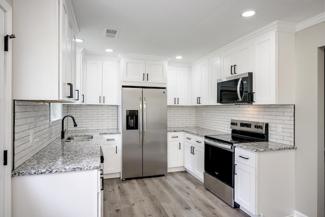 1178 Huntly Cir, Thomson, GA 30824 - kitchen featuring stainless steel appliances, light stone countertops, backsplash, and recessed lighting