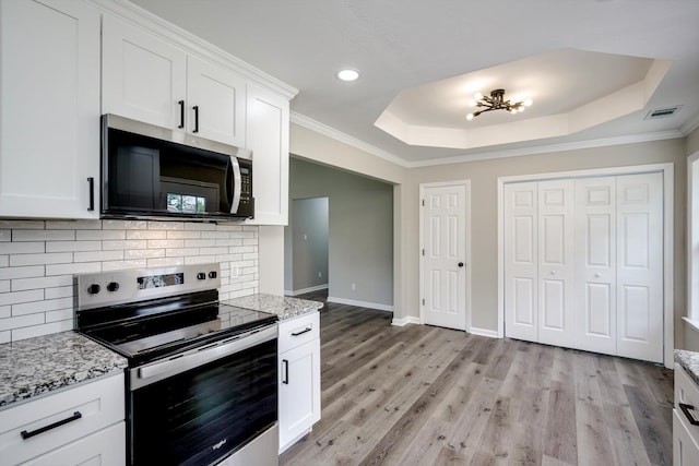 1178 Huntly Cir, Thomson, GA 30824 - kitchen featuring appliances with stainless steel finishes, a tray ceiling, backsplash, recessed lighting, and white cabinetry