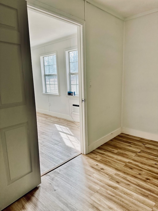 entryway featuring ornamental molding and light hardwood / wood-style floors