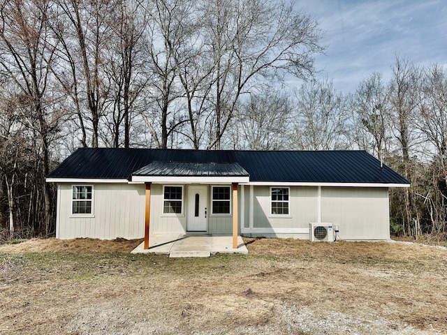 view of front of property featuring ac unit and a patio