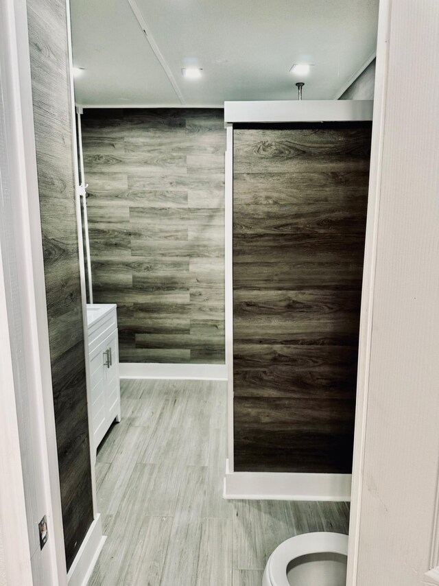 bathroom with vanity, hardwood / wood-style flooring, and toilet