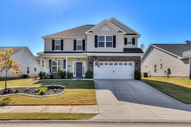 view of front property with a front yard, a garage, and cooling unit