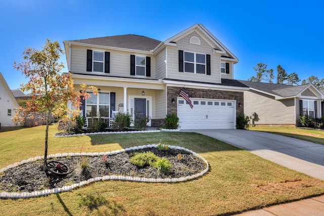 view of front of house with a front lawn, concrete driveway, covered porch, stone siding, and an attached garage