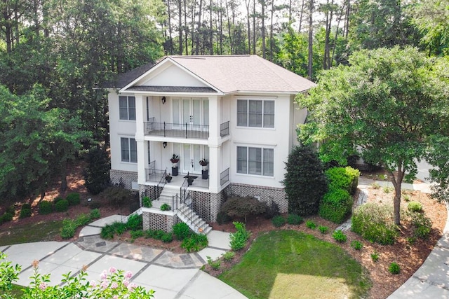 18 Pavilion Lake Rd, North Augusta, SC 29860 - view of front of home featuring a balcony, brick siding, a shingled roof, stairway, and a porch