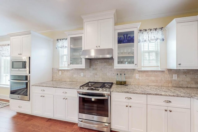 kitchen with white cabinetry, under cabinet range hood, and stainless steel appliances