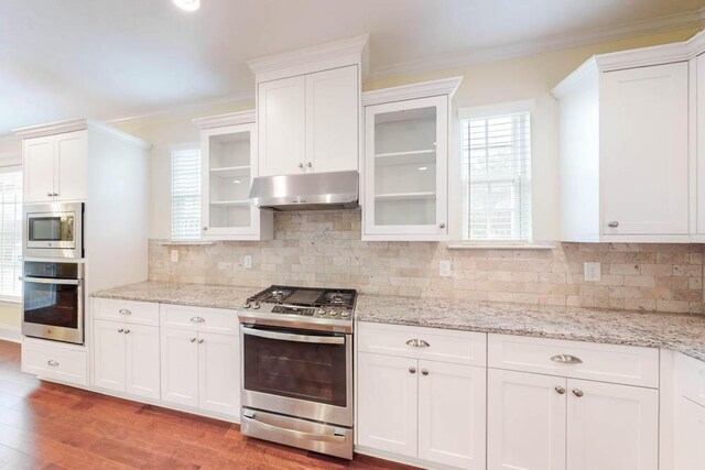 1190 Tralee Dr, Beech Island, SC 29842 - kitchen with stainless steel appliances, under cabinet range hood, crown molding, white cabinets, and light wood-style flooring