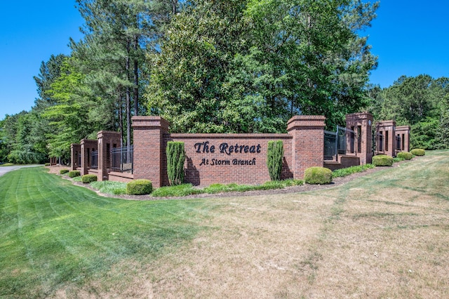 community / neighborhood sign with a lawn