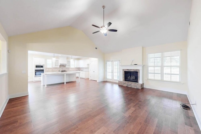 1190 Tralee Dr, Beech Island, SC 29842 - unfurnished living room featuring ceiling fan, a fireplace, dark wood-style floors, and high vaulted ceiling