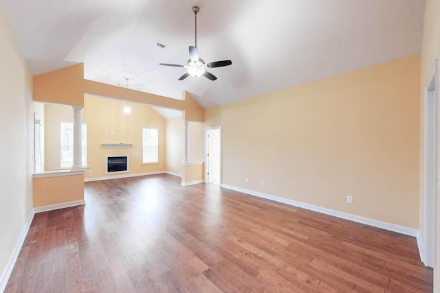1190 Tralee Dr, Beech Island, SC 29842 - unfurnished living room featuring a ceiling fan, wood finished floors, lofted ceiling, a glass covered fireplace, and decorative columns