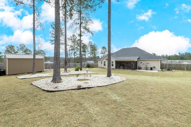 view of yard featuring an outbuilding, a patio area, and fence private yard