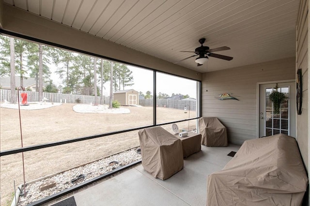 sunroom / solarium with ceiling fan and wooden ceiling