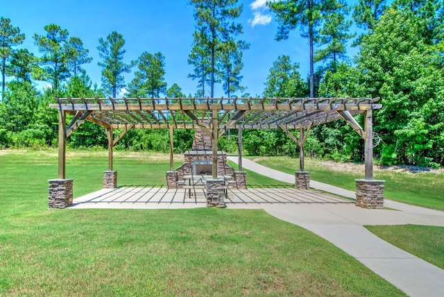 view of community with a patio, a lawn, and a pergola