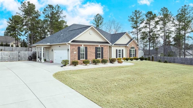 view of front facade featuring brick siding, an attached garage, a front lawn, and fence