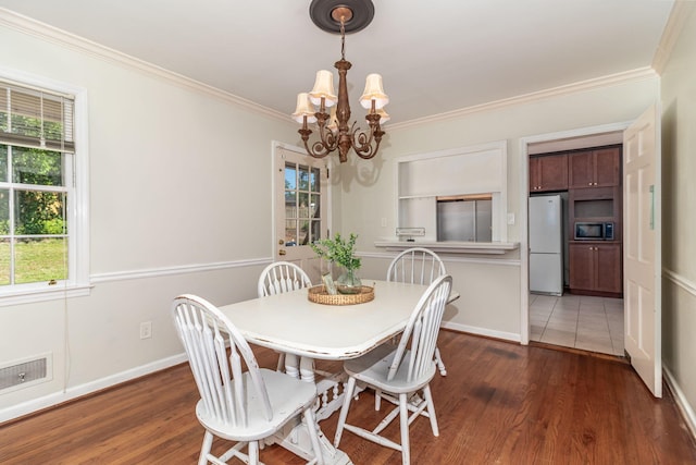751 Lancaster Rd, Augusta, GA 30909 - dining area with a chandelier, healthy amount of natural light, wood finished floors, and crown molding