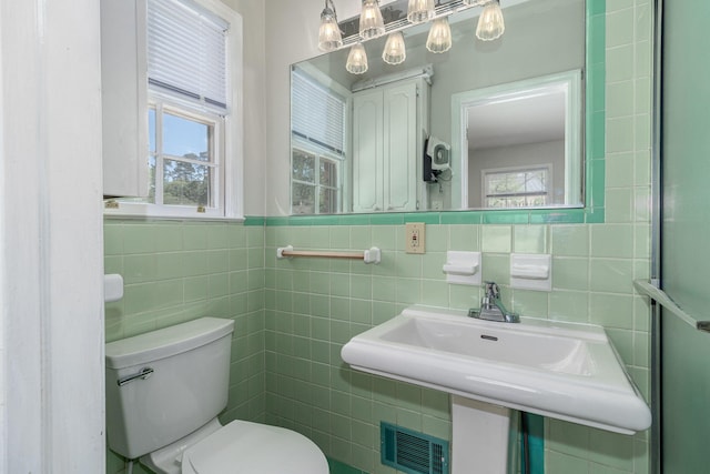 751 Lancaster Rd, Augusta, GA 30909 - bathroom with tile walls, toilet, and a sink
