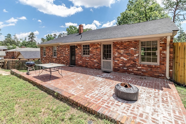 751 Lancaster Rd, Augusta, GA 30909 - back of property with an outdoor fire pit, a patio area, roof with shingles, and brick siding