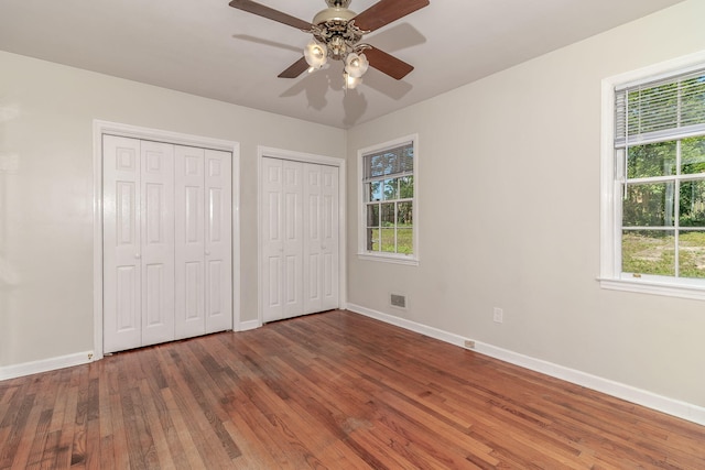 751 Lancaster Rd, Augusta, GA 30909 - unfurnished bedroom with two closets, baseboards, and multiple windows