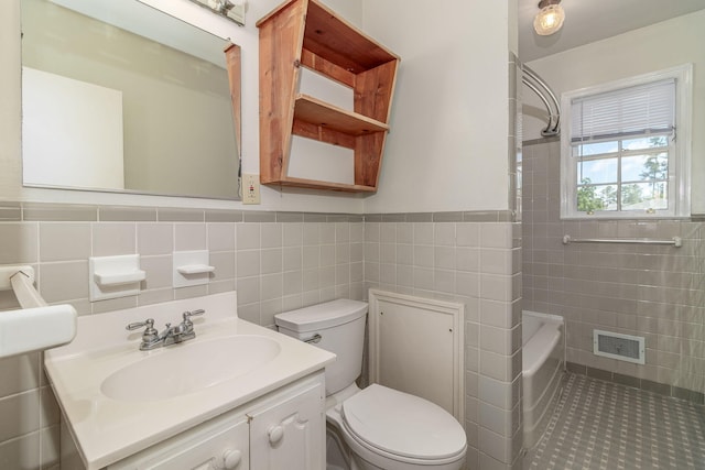 751 Lancaster Rd, Augusta, GA 30909 - full bath featuring tile walls, toilet, vanity, wainscoting, and washtub / shower combination