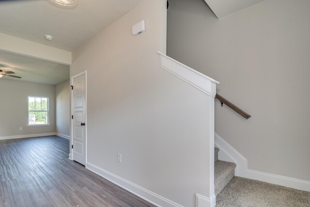 staircase with ceiling fan, baseboards, and wood finished floors