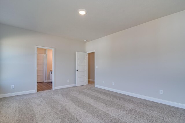 empty room with light carpet and baseboards