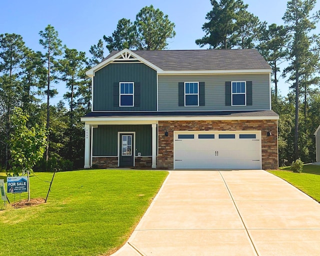 craftsman house featuring a garage, board and batten siding, concrete driveway, and a front yard