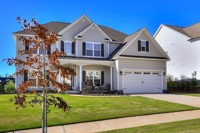 craftsman inspired home featuring a front yard and a garage