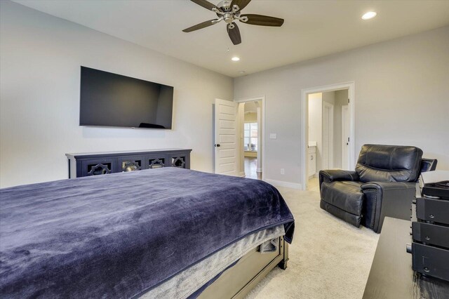 carpeted bedroom with ceiling fan and ensuite bathroom