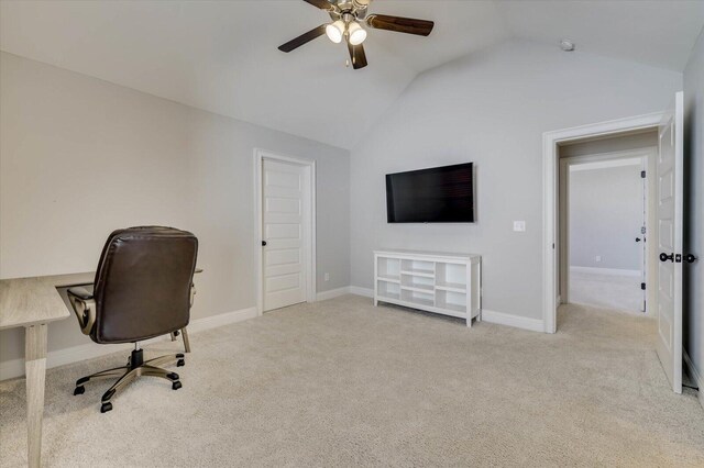 carpeted home office featuring ceiling fan and vaulted ceiling