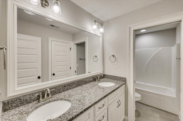 bathroom with tile patterned floors, vanity, and toilet