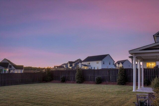 view of yard at dusk