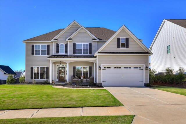 craftsman-style house with a front lawn, covered porch, and a garage