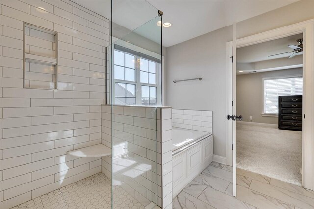 bathroom featuring independent shower and bath