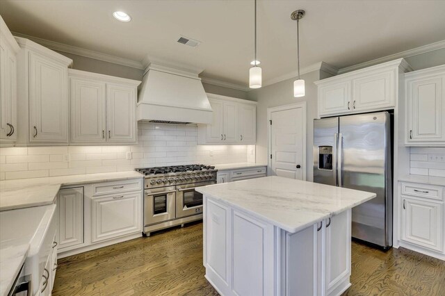 kitchen with premium range hood, dark hardwood / wood-style flooring, white cabinets, and stainless steel appliances