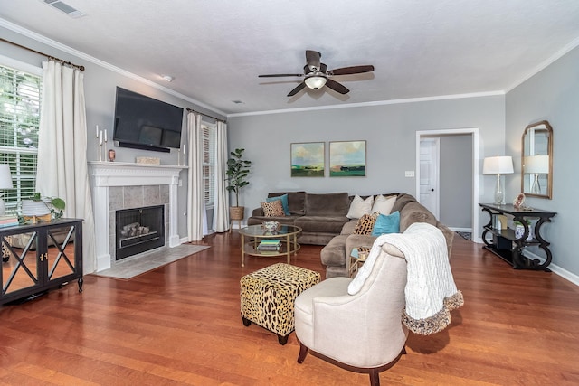 503 Pavilion Ct, Martinez, GA 30907 - living area featuring a ceiling fan, a tiled fireplace, wood finished floors, and ornamental molding