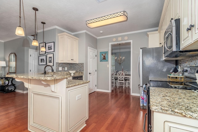503 Pavilion Ct, Martinez, GA 30907 - kitchen featuring stainless steel appliances, cream cabinetry, dark wood-style floors, a peninsula, and decorative backsplash