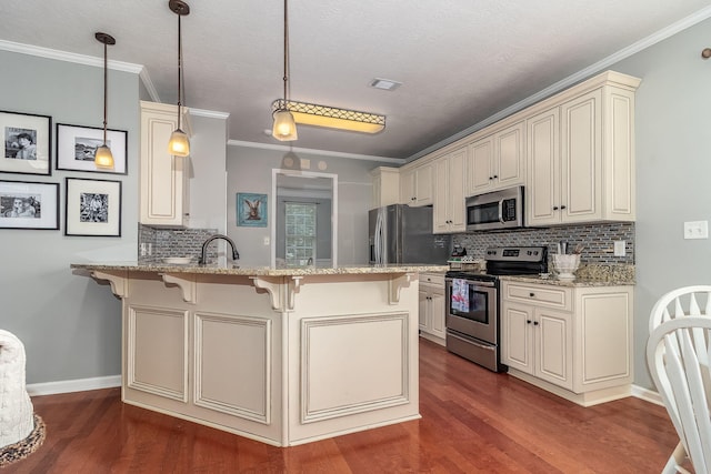 503 Pavilion Ct, Martinez, GA 30907 - kitchen featuring stainless steel appliances, cream cabinets, a kitchen breakfast bar, a peninsula, and decorative backsplash