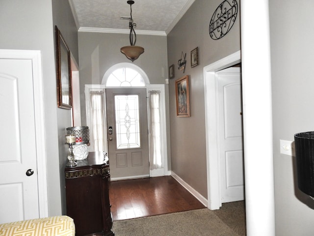 entrance foyer with dark wood-type flooring and crown molding