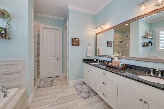 2084 Egret Cir, Evans, GA 30809 - bathroom featuring a shower stall, double vanity, ornamental molding, a garden tub, and baseboards