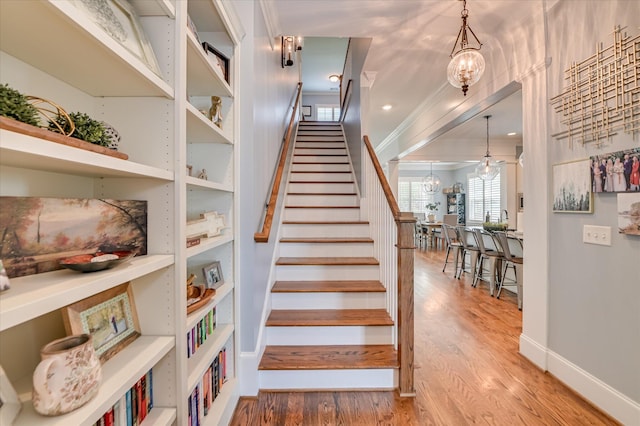 2084 Egret Cir, Evans, GA 30809 - staircase featuring wood finished floors, baseboards, and crown molding
