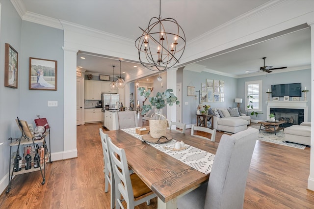 2084 Egret Cir, Evans, GA 30809 - dining space featuring ceiling fan, baseboards, ornamental molding, wood finished floors, and a chandelier