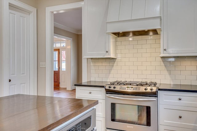 721 Bishops Cir, Evans, GA 30809 - kitchen with crown molding, stainless steel range with gas cooktop, white cabinets, and backsplash