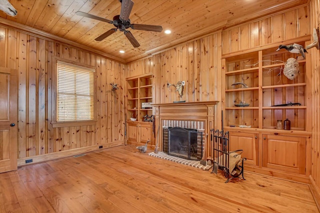 721 Bishops Cir, Evans, GA 30809 - living room featuring wood walls, a fireplace, wood ceiling, and light hardwood / wood-style floors
