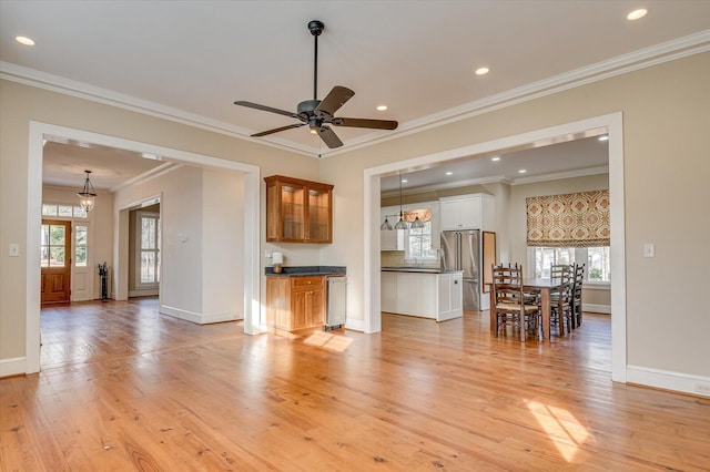 721 Bishops Cir, Evans, GA 30809 - living room featuring crown molding, a healthy amount of sunlight, ceiling fan with notable chandelier, and light hardwood / wood-style floors